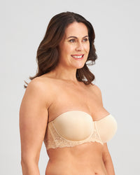 Model wears Bendon Bare Lace Back Strapless Bra in LATTE. On body side view