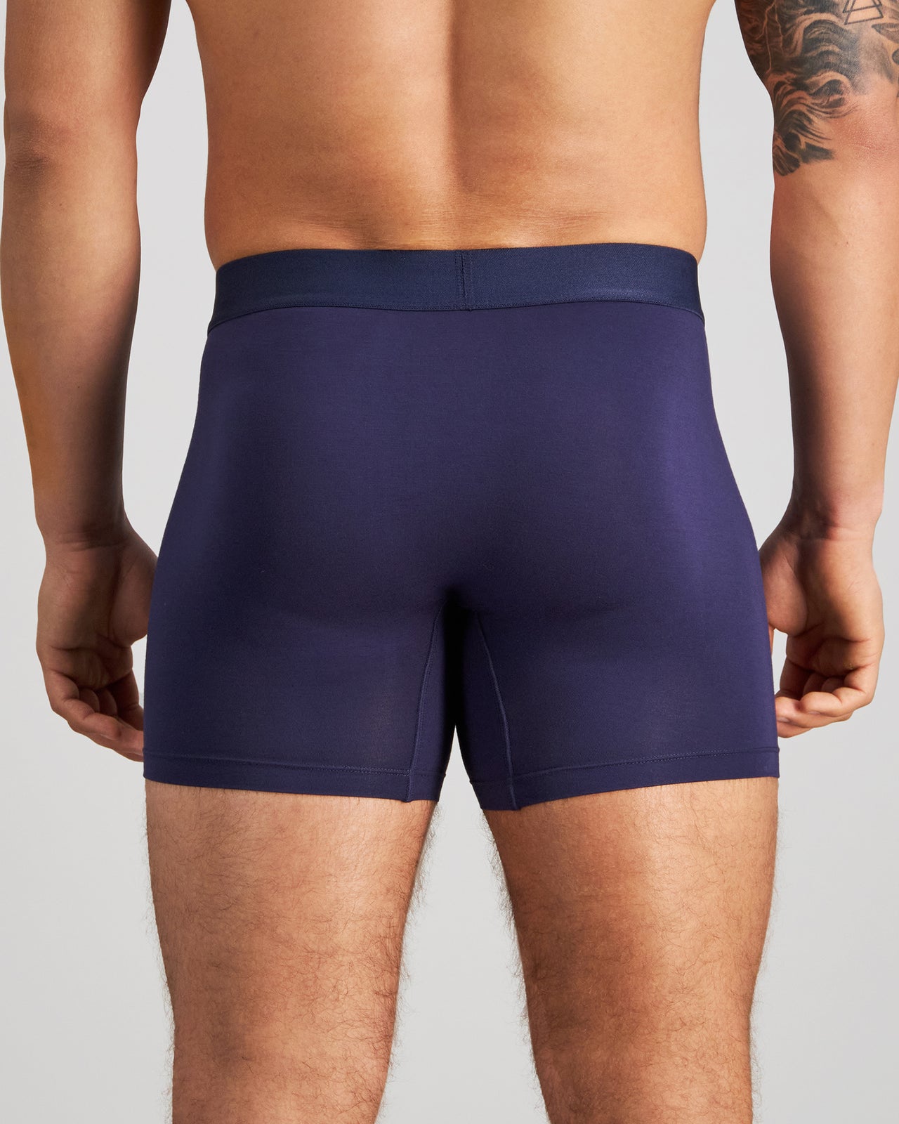 Model wears Bamboo Mens Trunk in PEACOAT. On body back view
