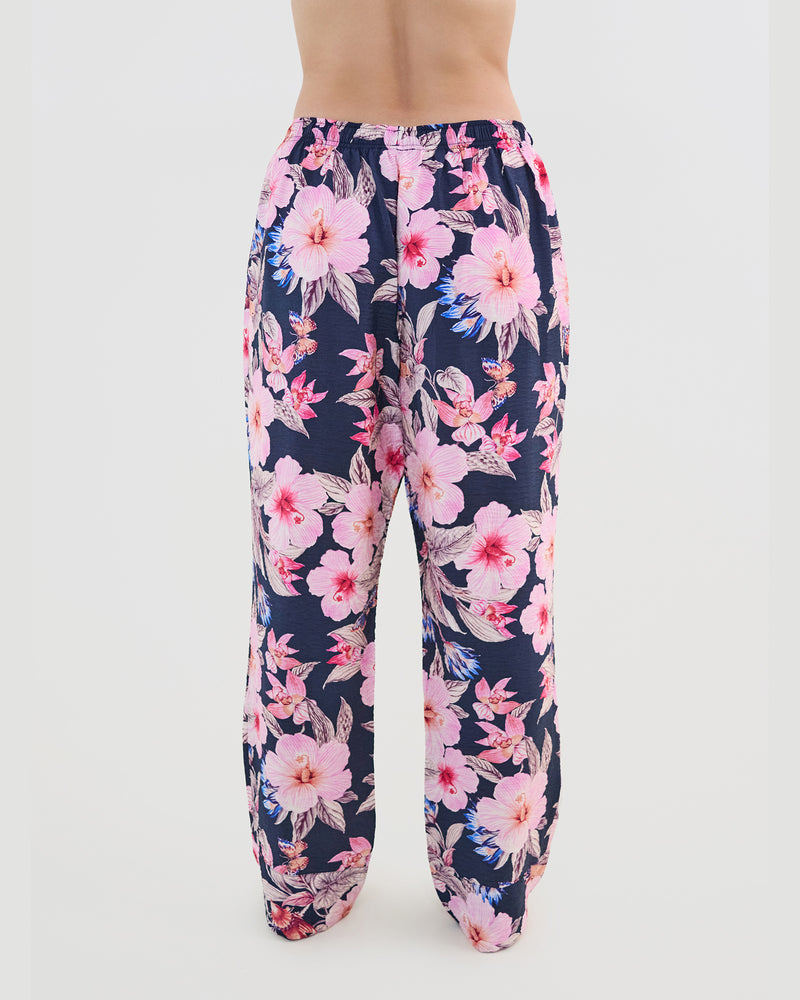Model wears Mihika Sleeping Long PJ Pant in HONOLULU HAZE PRINT. On body back view