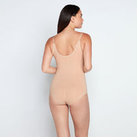 Model wears Medium Control Bodysuit in CARAMEL. On body back view