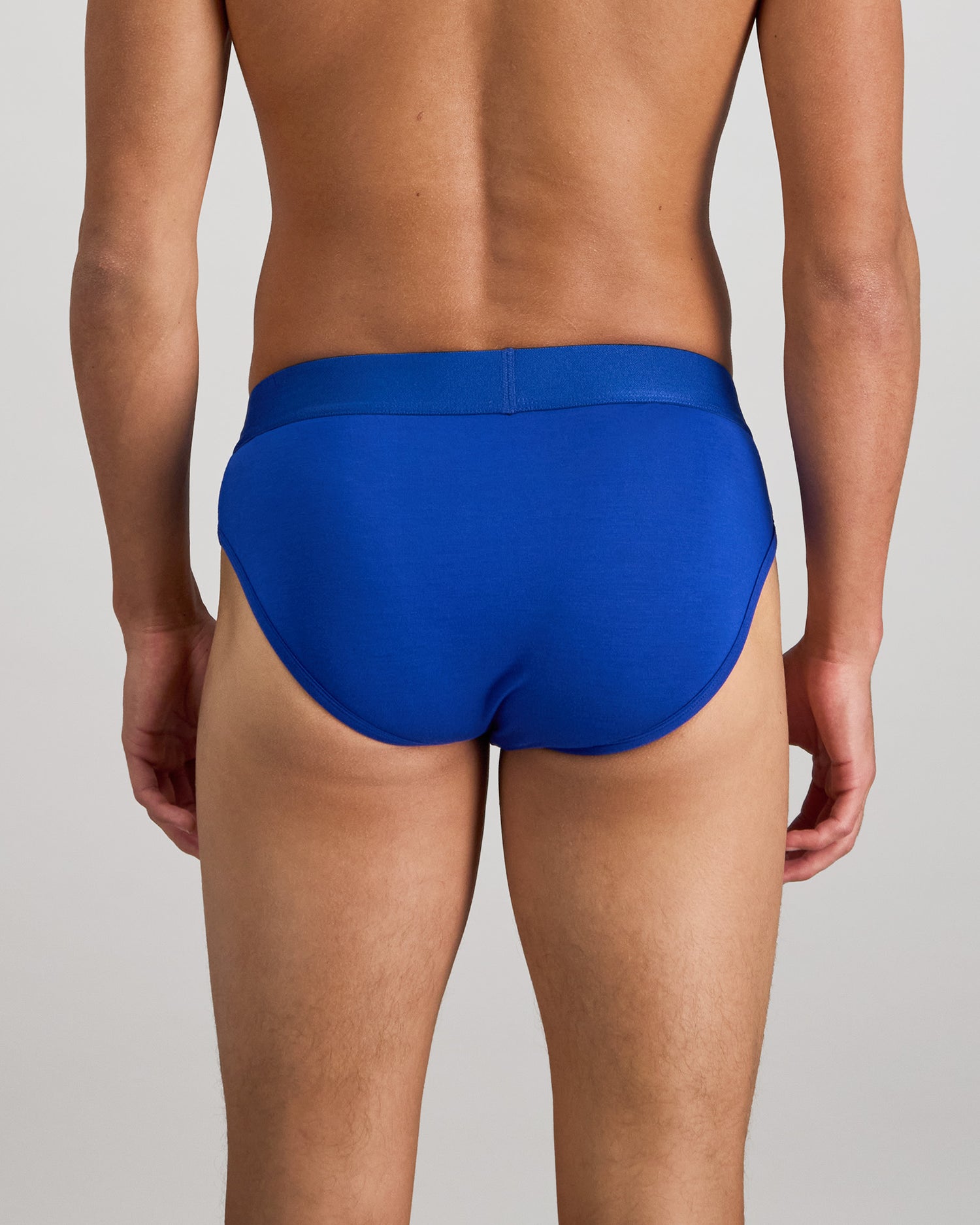 Model wears Bamboo Mens Brief in Surf The Web. On body back view