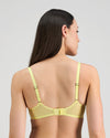 Model wears Elevate Underwire Bra in LEMON MERINGUE. On body back view