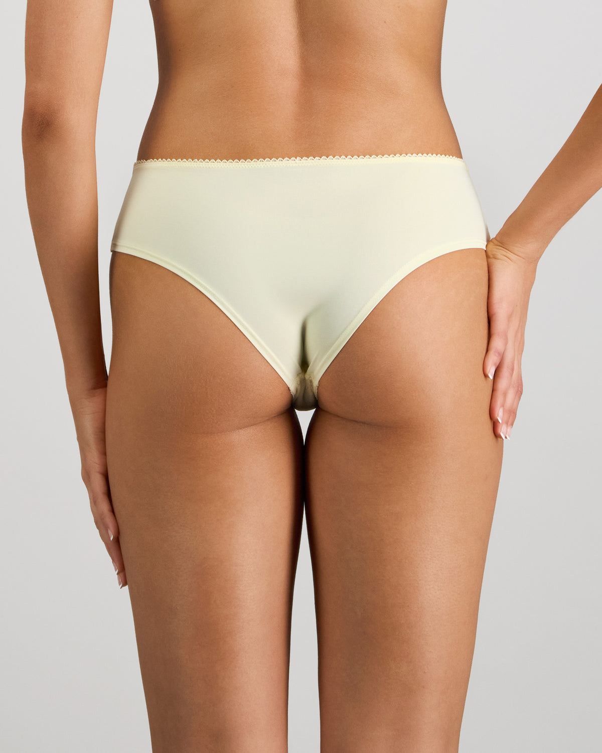 Model wears Lacey Brazilian in TRANSPARENT YELLOW. On body back view