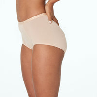 Model wears Body Cotton Full Brief in NATURAL. On body side view