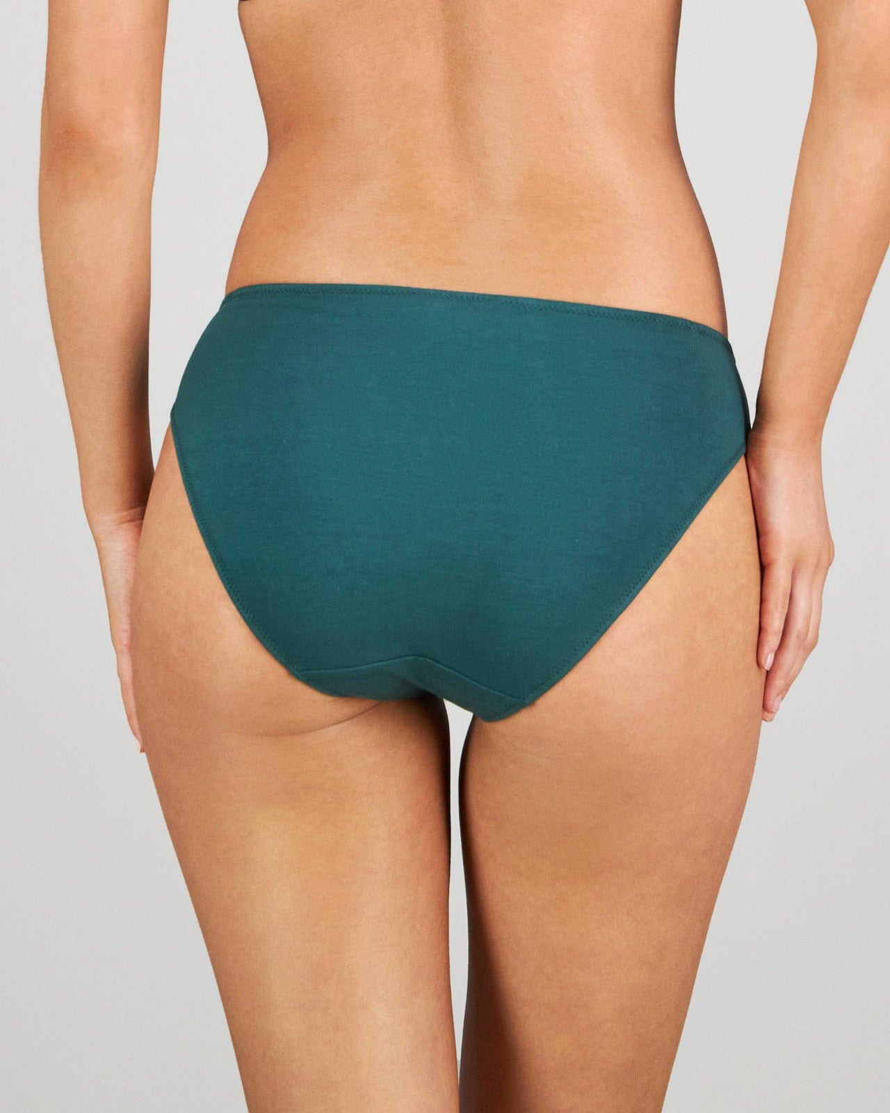 Model wears Embrace Bikini in RAIN FOREST. On body back view