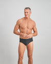 Model wears Cotton Stretch Mens Brief in CHAR BLACK. On body front view