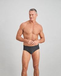 Model wears Cotton Stretch Mens Brief in CHAR BLACK. On body front view