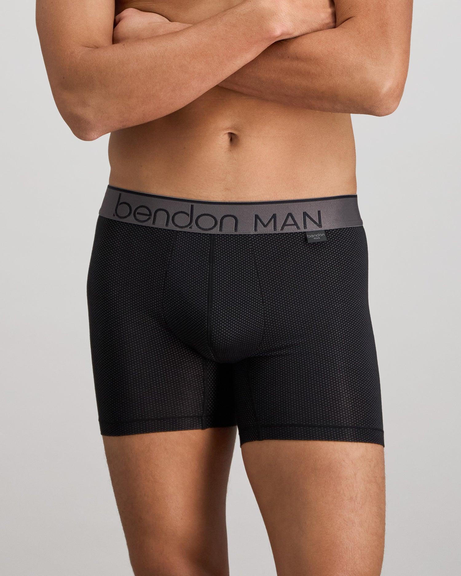 Model wears Everyday Active Mens Long Trunk in BLACK. On body front view