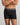 Model wears Everyday Active Mens Long Trunk in BLACK. On body front view