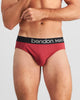 Model wears Everyday Essential Mens Brief in TIBETAN RED. On body front view