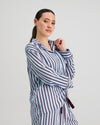 Model wears Cabana Stripe Long Sleeve Pj Top in COOL BLUE. On body side view
