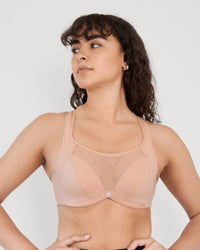Model wears Power Underwire Bra in LATTE. On body front view