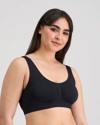 Model wears Bendon Essentials Crop Top in BLACK. On body side view