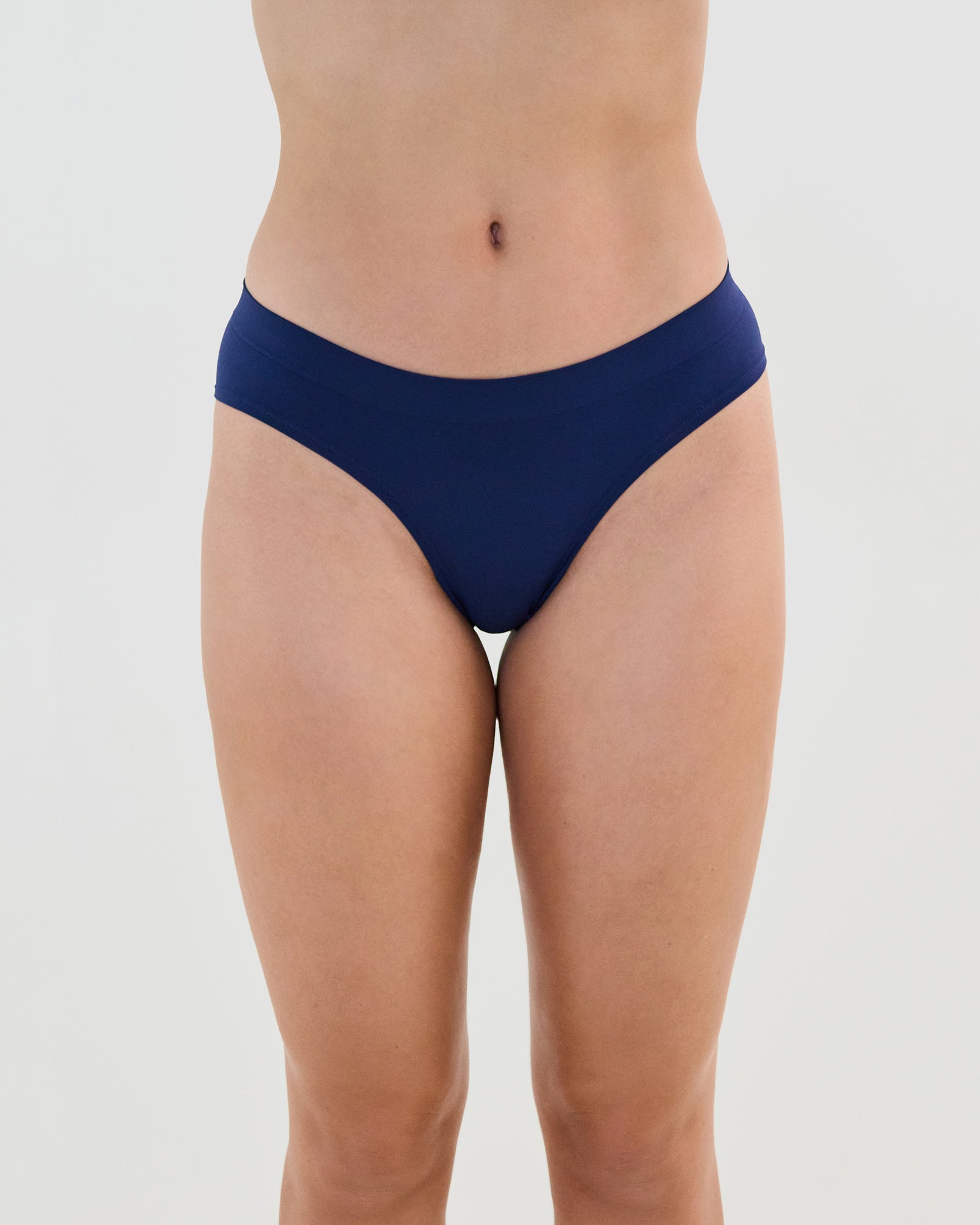 Model wears Seamless Soft Bikini in Medieval Blue. On body front view