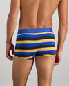 Model wears Rugby Stripe Mens Trunk in BLACK/SURF/OAK BUFF. On body back view
