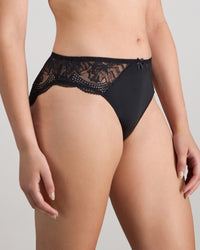 Model wears Aria High Cut Brief in BLACK. On body side view