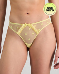 Model wears Sunlit Thong in LEMON MERINGUE. On body front view