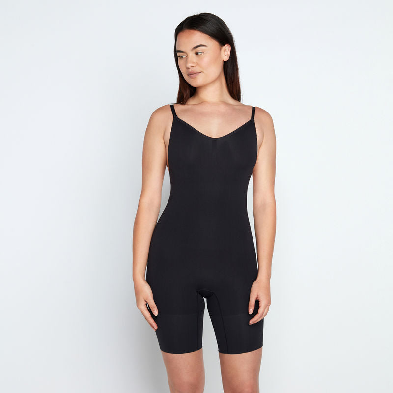 Model wears Medium Control Jumpsuit in BLACK. On body front view