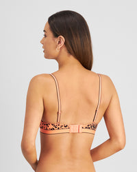 Model wears Uplift Me Push Up Bra in LIVING CORAL LEOPARD PRINT. On body back view
