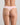 Model wears Seamless Soft Thong in ICY PINK. On body back view