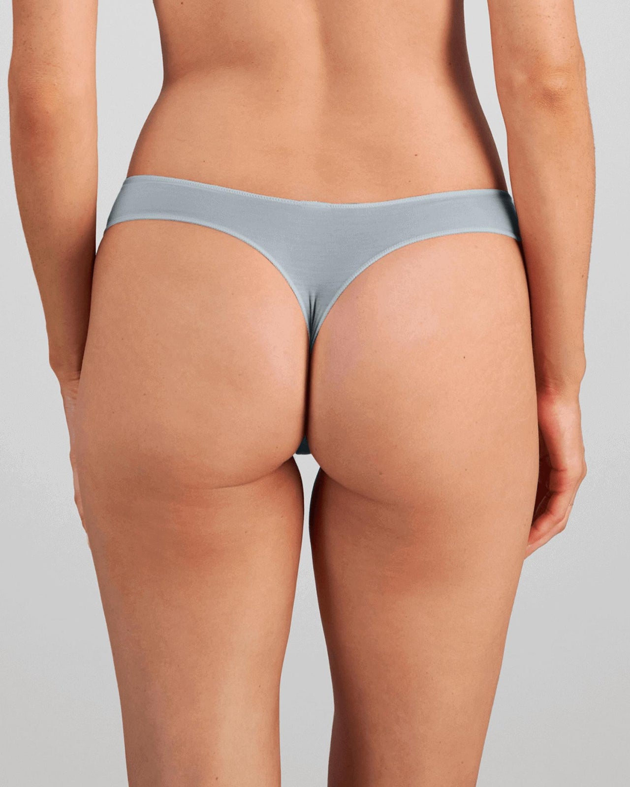 Model wears Au Naturel Thong in SLATE. On body back view