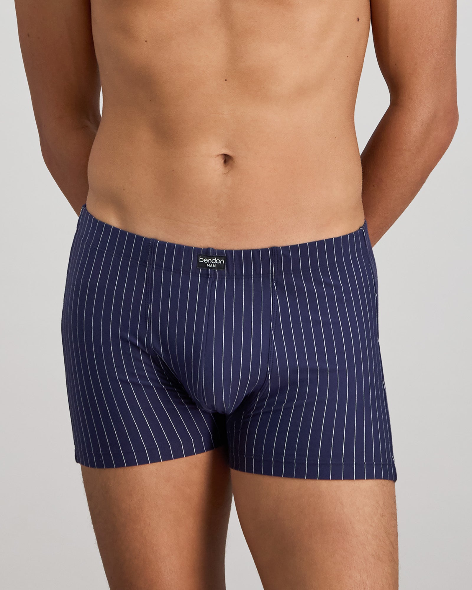 Model wears Cotton Stretch Mens Trunk in PEACOAT PINSTRIPE. On body front view