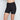 Model wears Everyday Light Hold Chafer Short in BLACK. On body front view