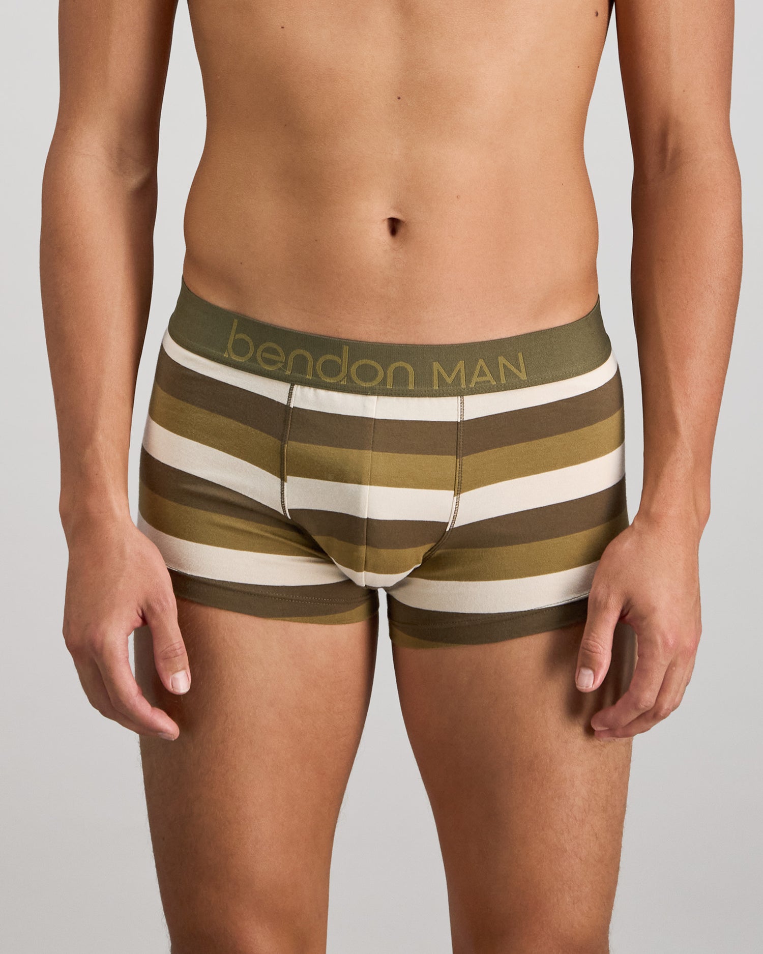 Model wears Rugby Stripe Mens Trunk in OLIVE/NUTRIA/OATMEAL. On body front view