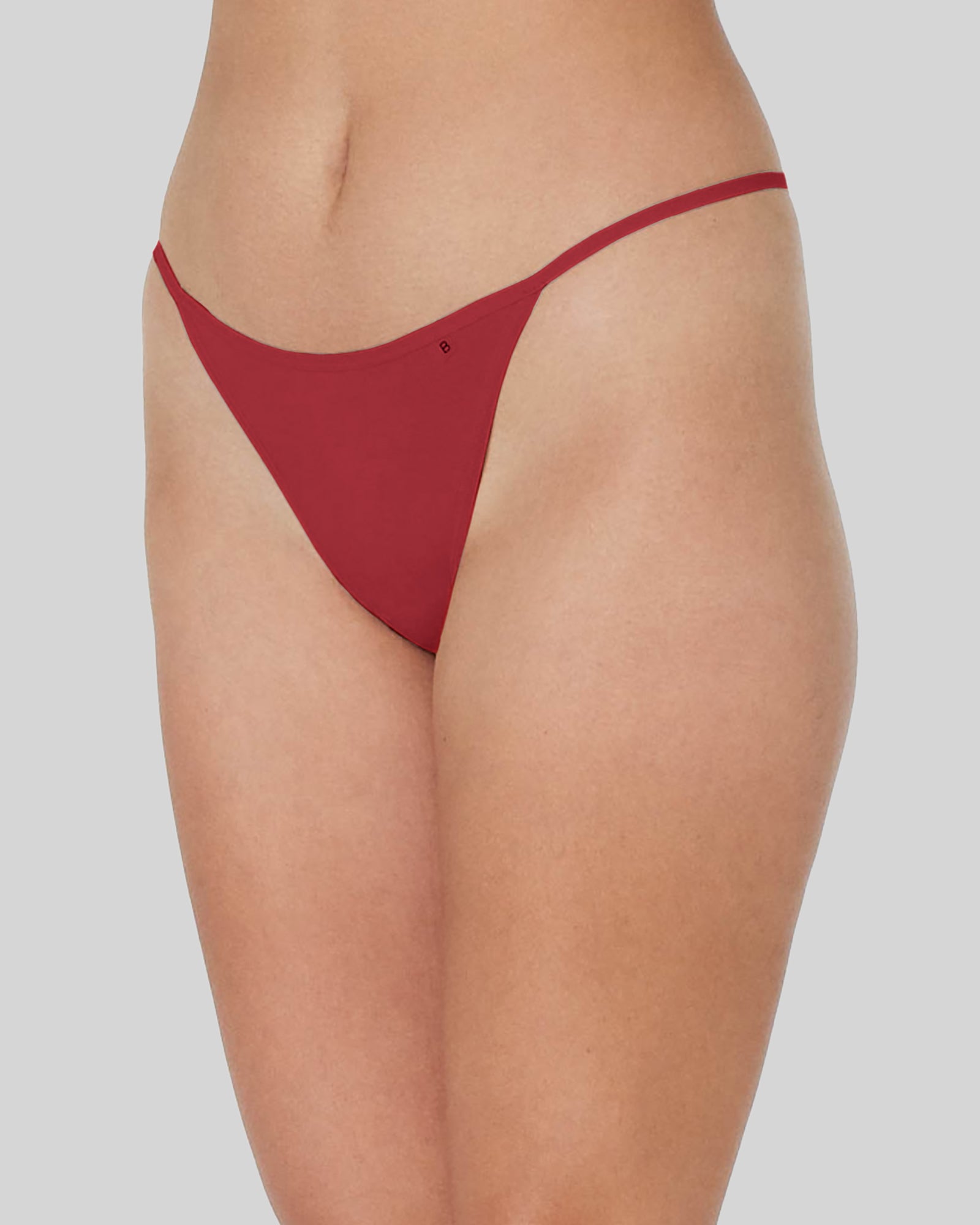 Model wears Clemence Thong in JESTER RED. On body side view
