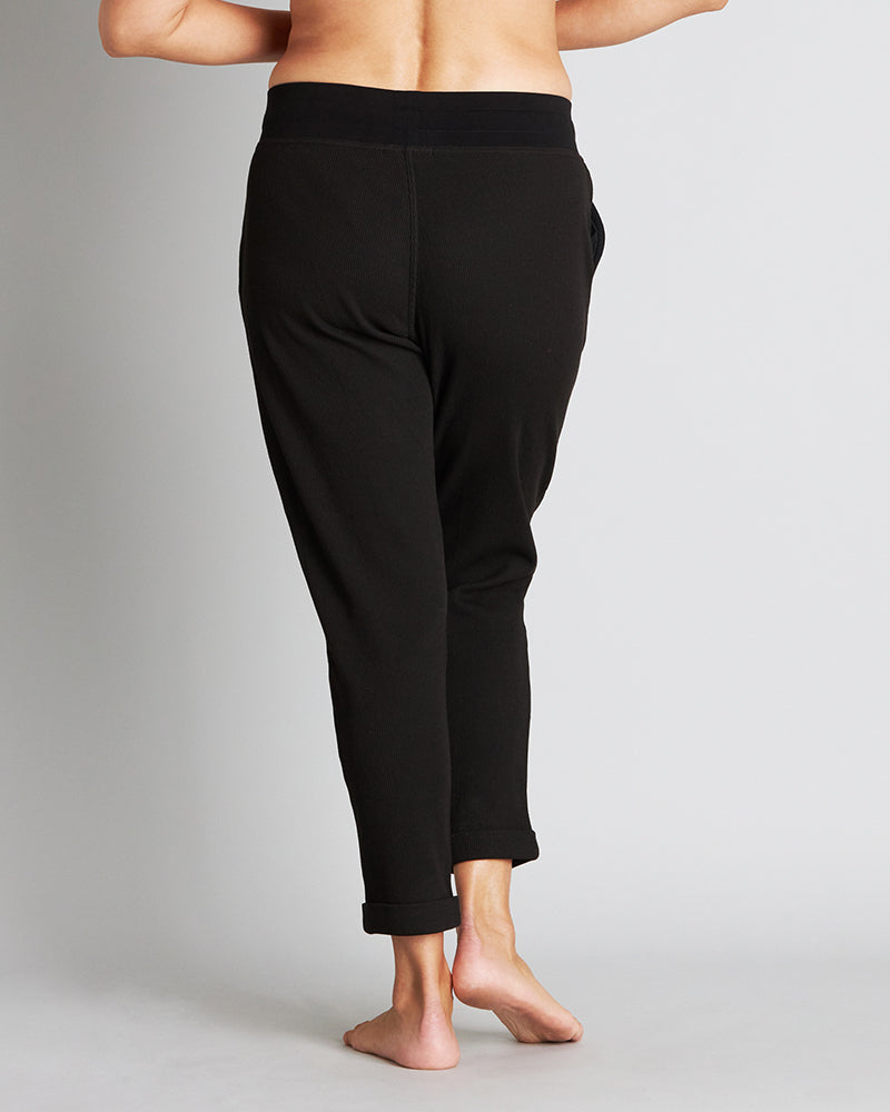 Model wears Mihika Sleeping Jogger in BLACK. On body back view