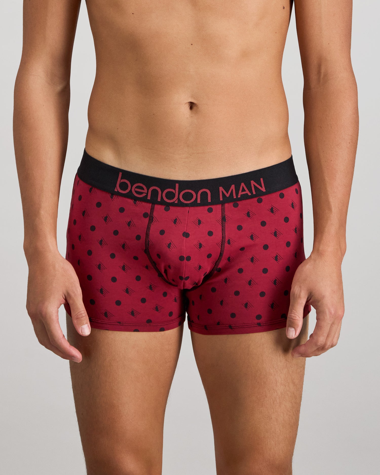 Model wears Retros Print Mens Trunk in DISRUPTED SPOT PRINT. On body front view