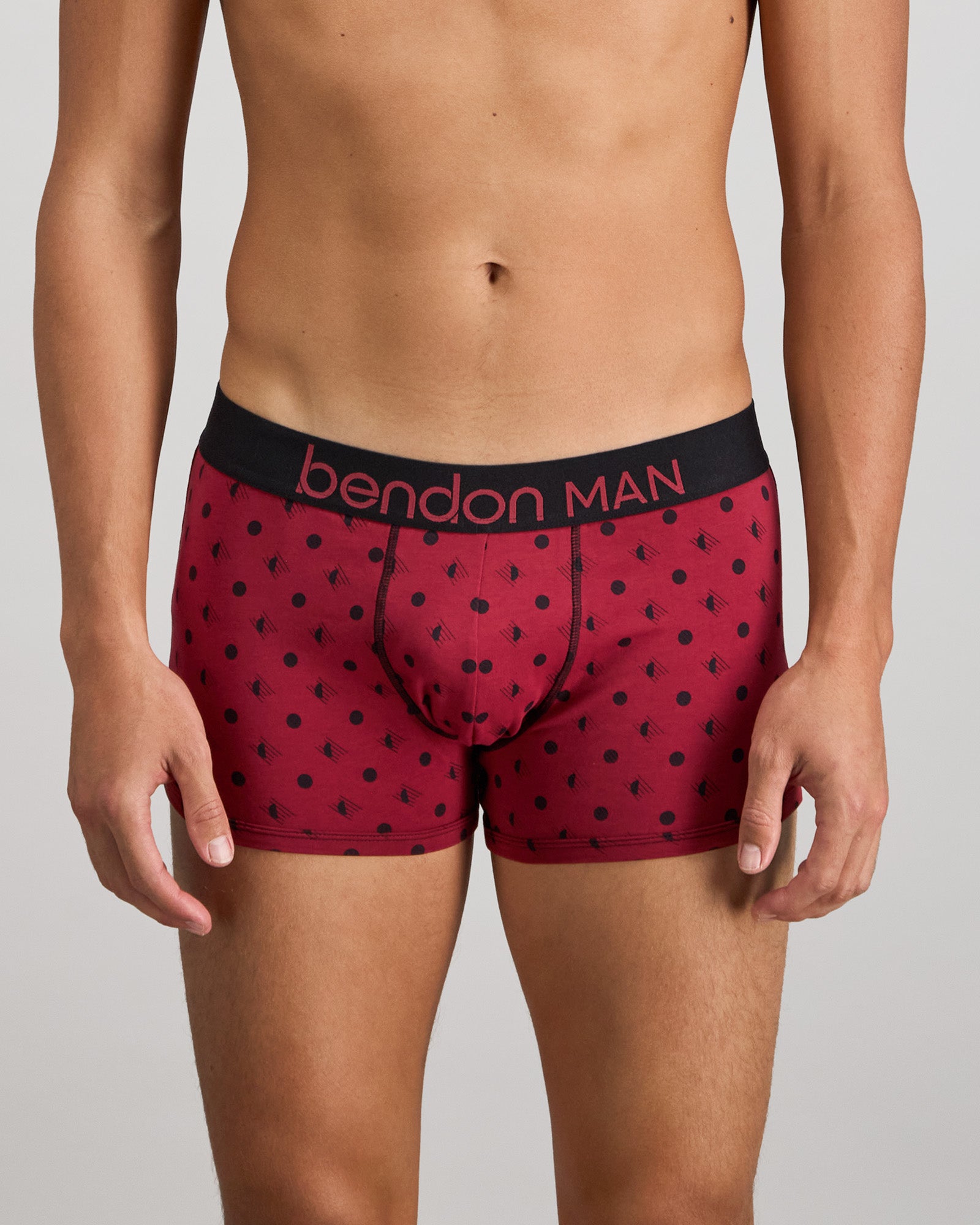 Model wears Retros Print Mens Trunk in DISRUPTED SPOT PRINT. On body front view
