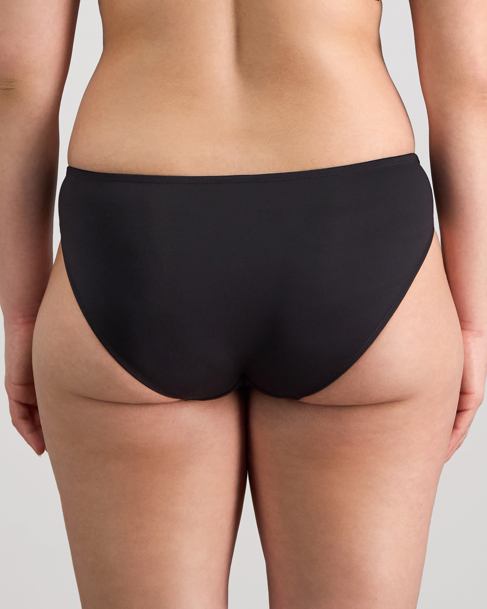 Model wears Juniper Bikini in BLACK. On body back view