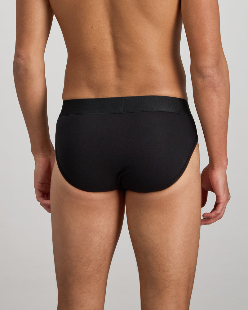 Model wears Bamboo Mens Brief in BLACK. On body back view