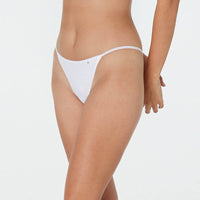 Model wears Clemence Thong in WHITE. On body front view