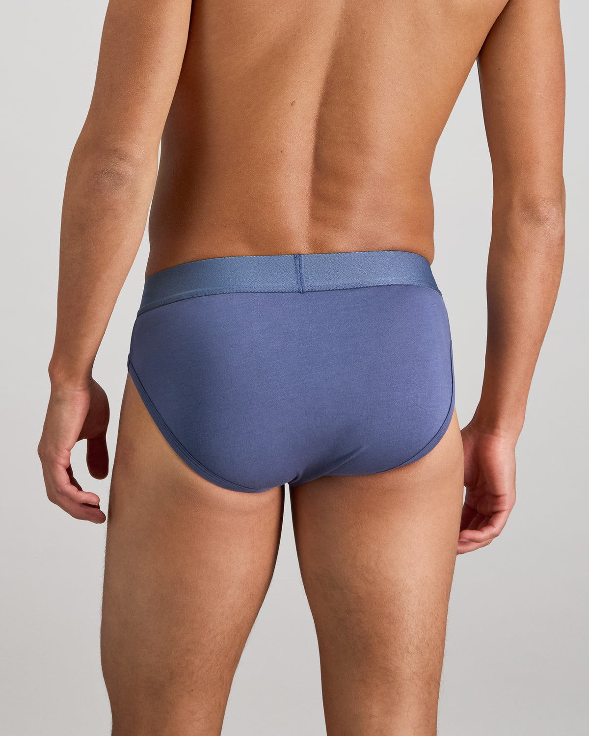 Model wears Bamboo Mens Brief in VINTAGE INDIGO. On body back view