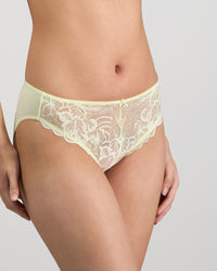 Model wears Embrace Bikini in TRANSPARENT YELLOW. On body side view
