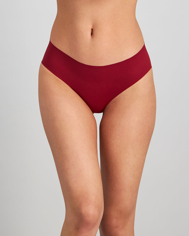 Model wears No Show Bikini in BIKING RED. On body front view