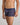 Model wears Bold Stripe Mens Trunk in PEACOAT/PLUM STRIPE. On body side view