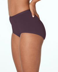 Model wears Body Cotton Full Brief in PLUM PERFECT. On body side view