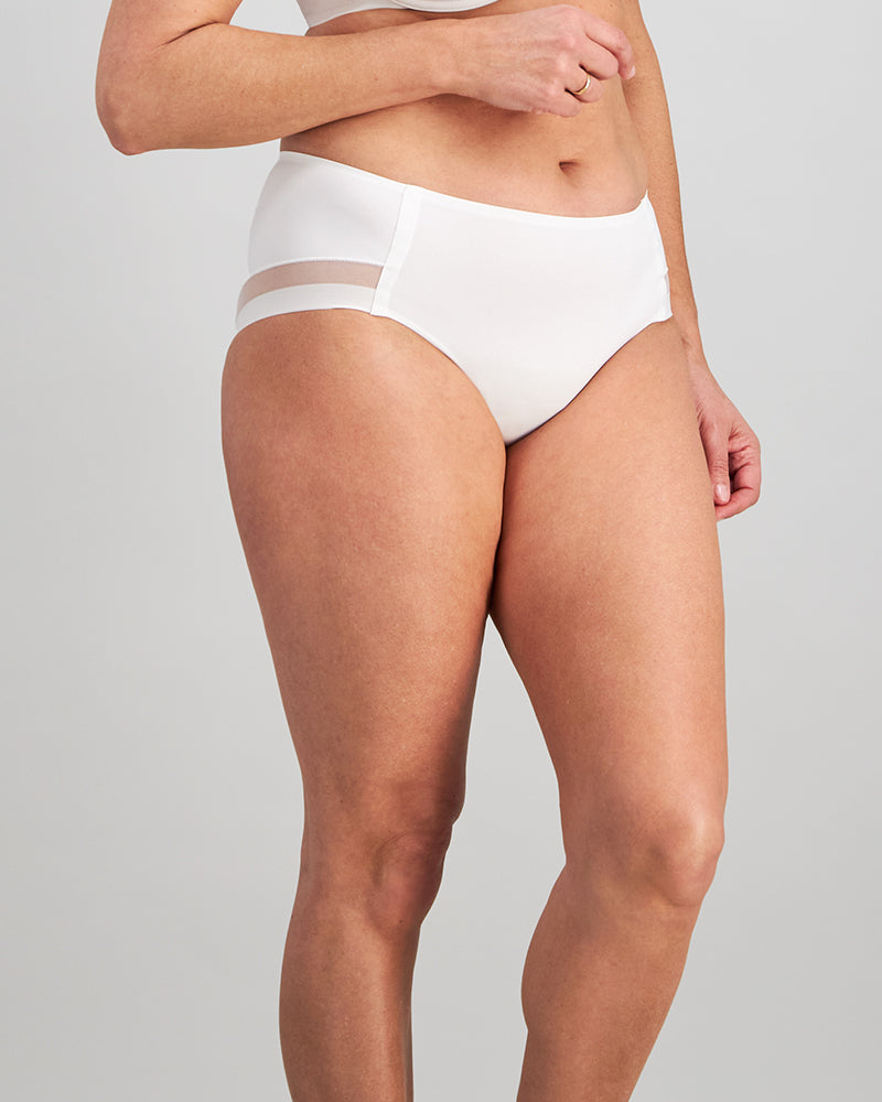 Model wears Comfit Collection Midi in WHITE. On body side view