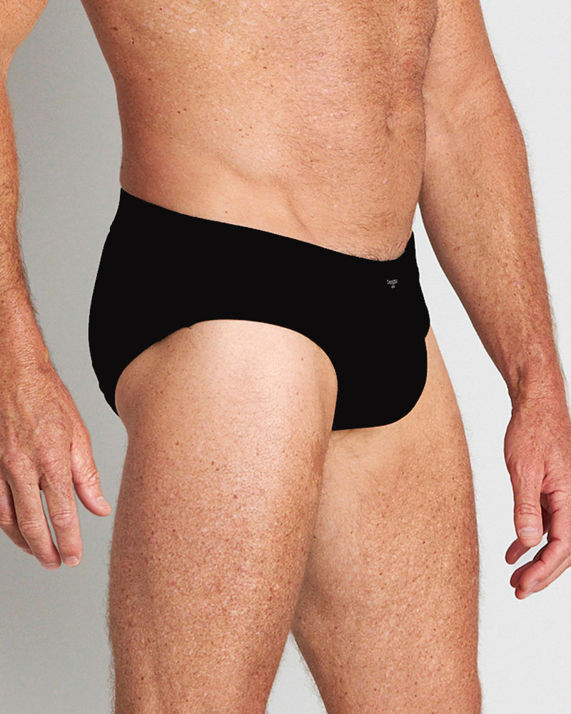 Model wears High Tech Cotton Mens Brief in BLACK. On body side view