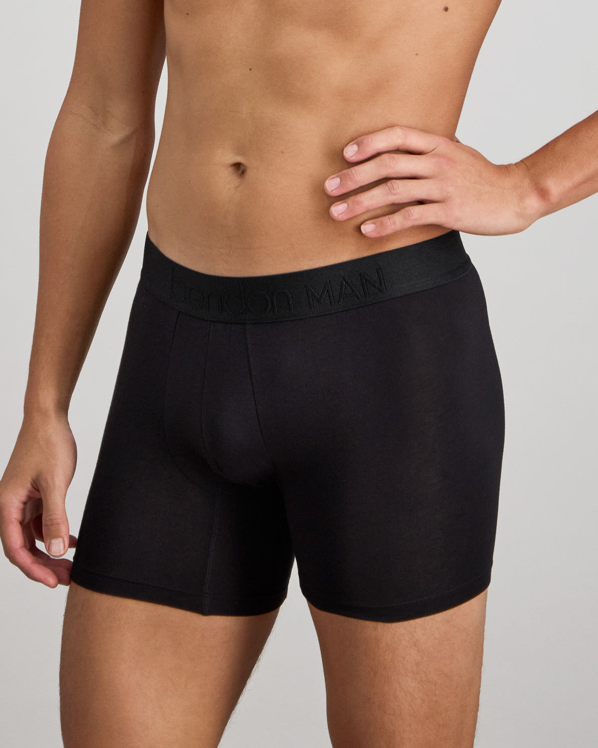 Model wears Bamboo Mens Trunk in BLACK. On body side view