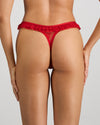 Model wears Tinsel Tease Thong in SALSA. On body back view