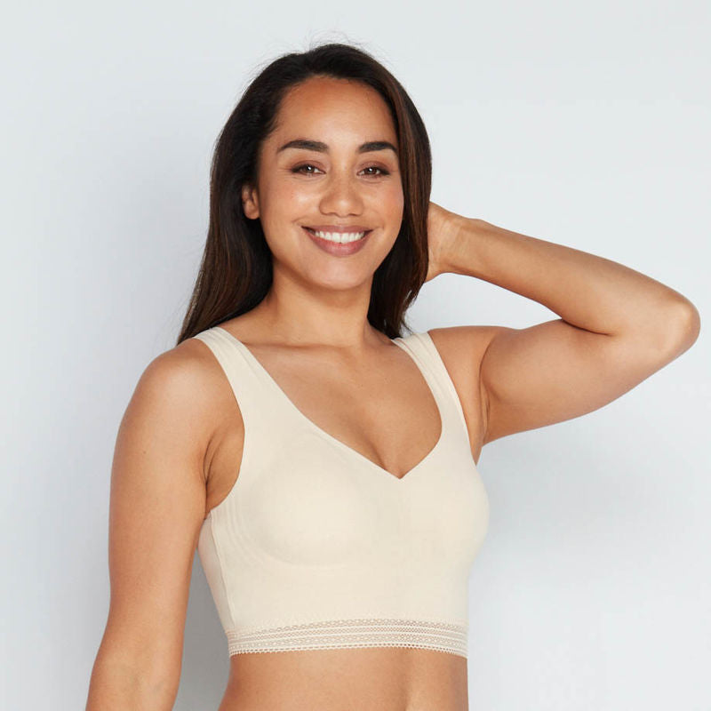 Model wears Comfit Collection Crop Top in NOVELLE PEACH. On body front view