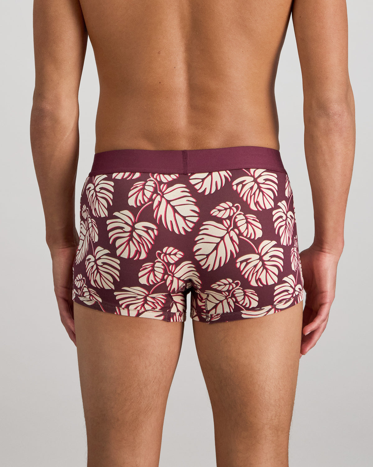 Model wears Retros Print Mens Trunk in FIG MONSTERA PRINT. On body back view