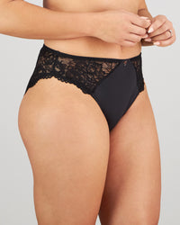 Model wears Laurel High Cut Brief in BLACK. On body side view