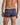 Model wears Bold Stripe Mens Trunk in PEACOAT/PLUM STRIPE. On body back view
