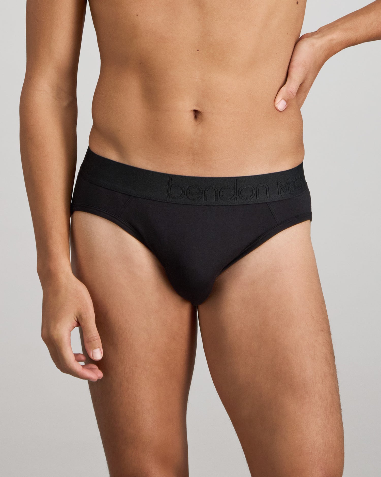 Model wears Bamboo Mens Brief in BLACK. On body front view