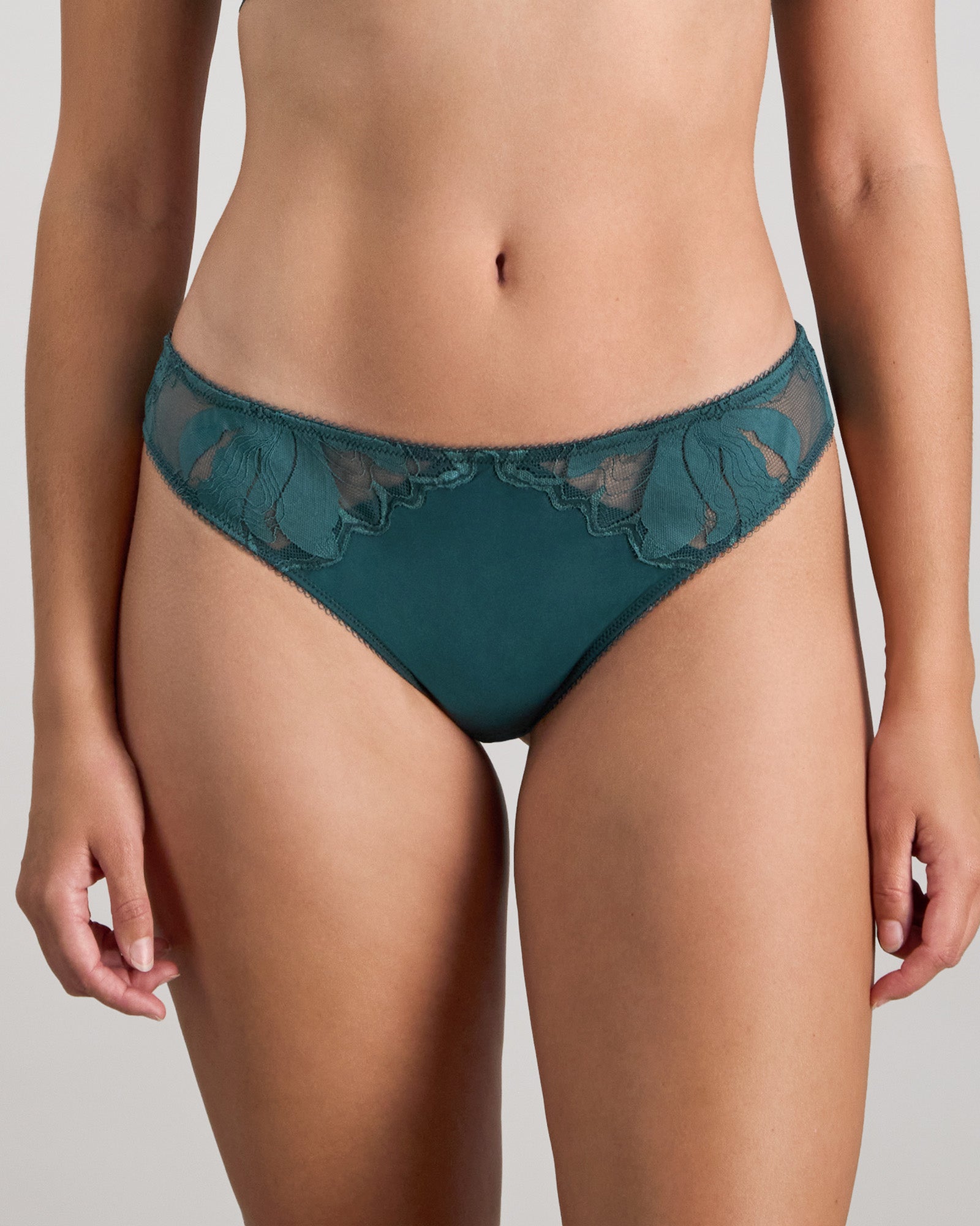 Model wears Margot Estelle Thong in MEDITERRANEA. On body front view